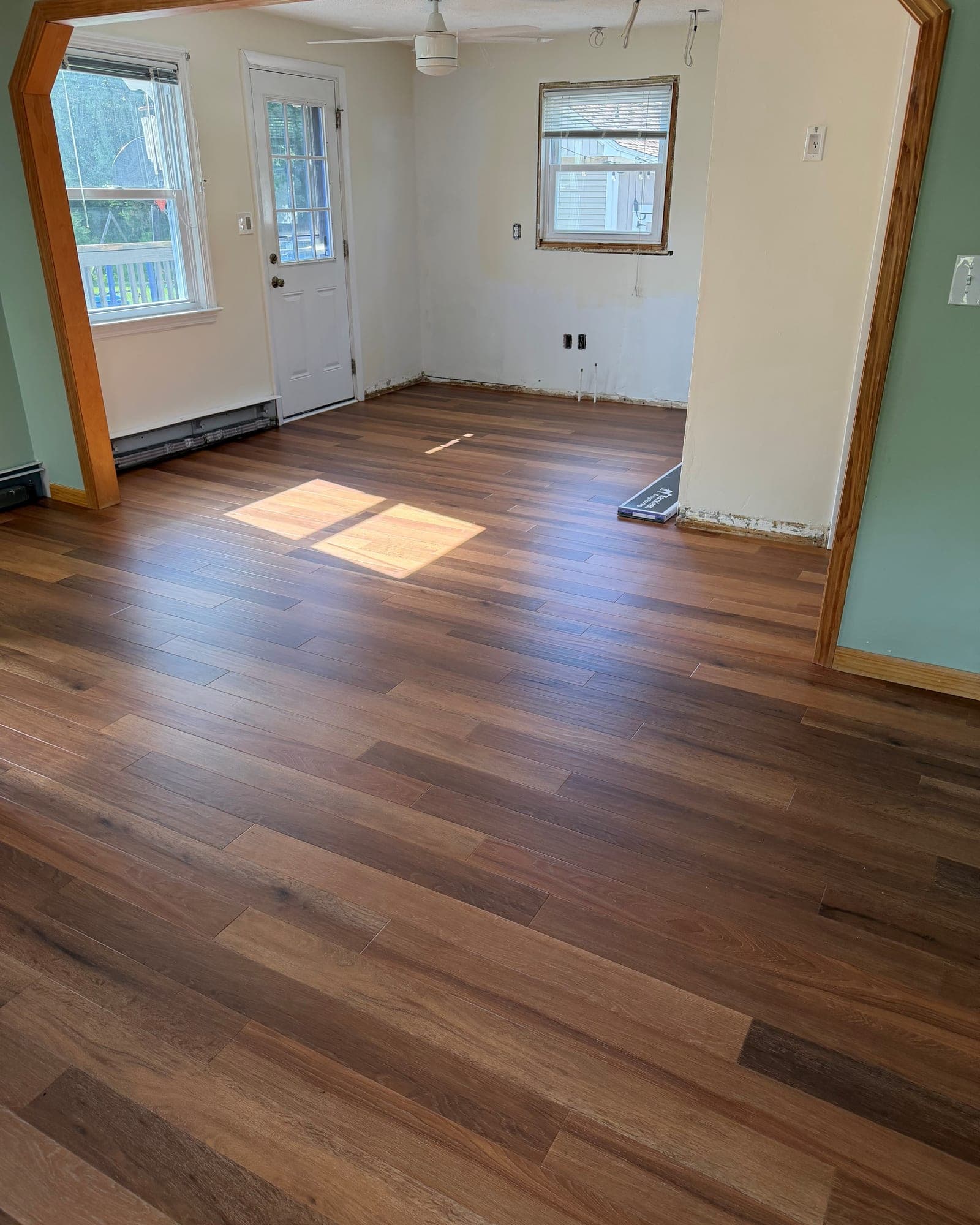 Karndean Art Select Golden Kent Ash flooring extending from a Bristol living room into the kitchen before cabinet installation